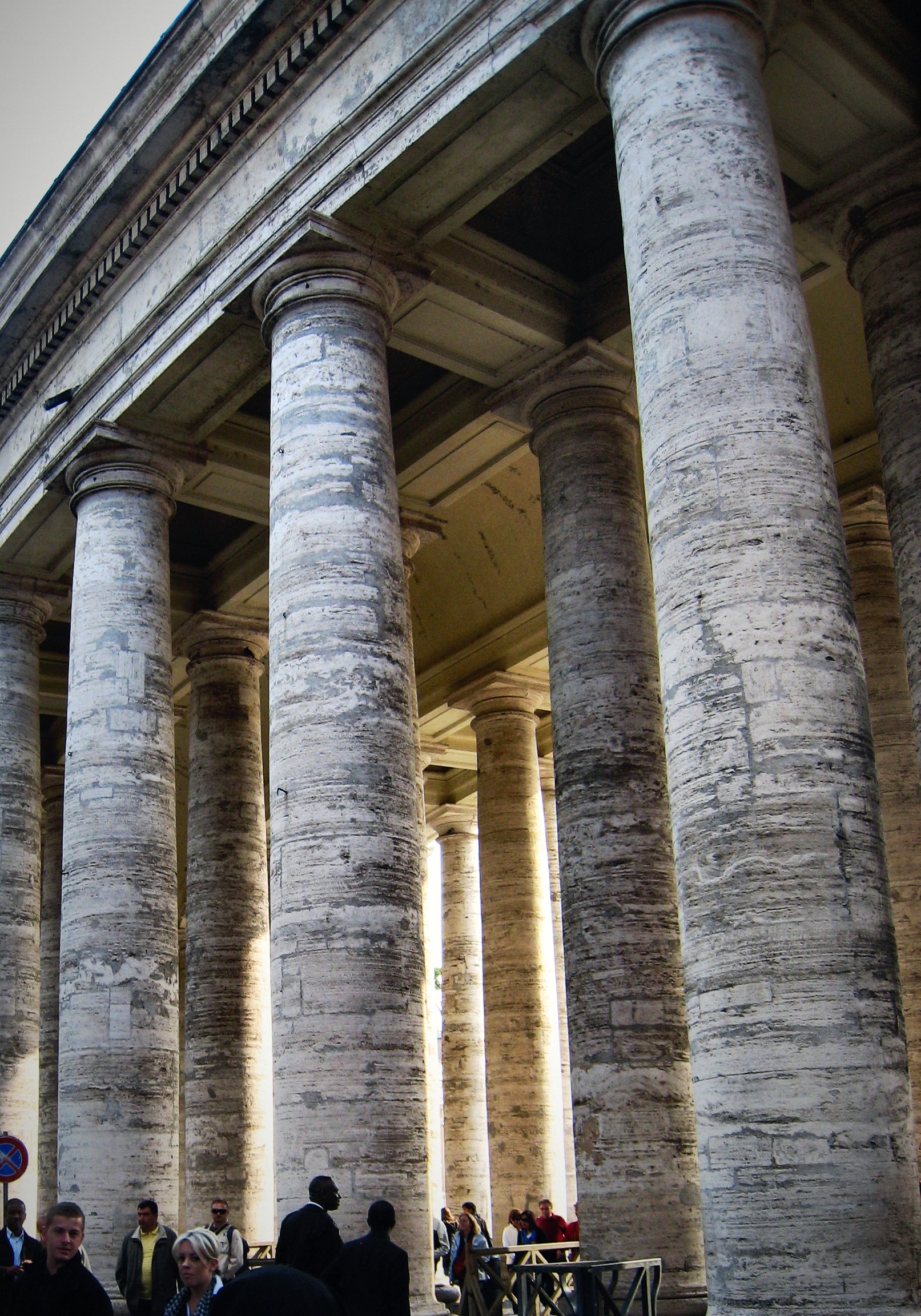 Massive columns of Bernini's colonnade at St Peter's Square marching into the distance.
