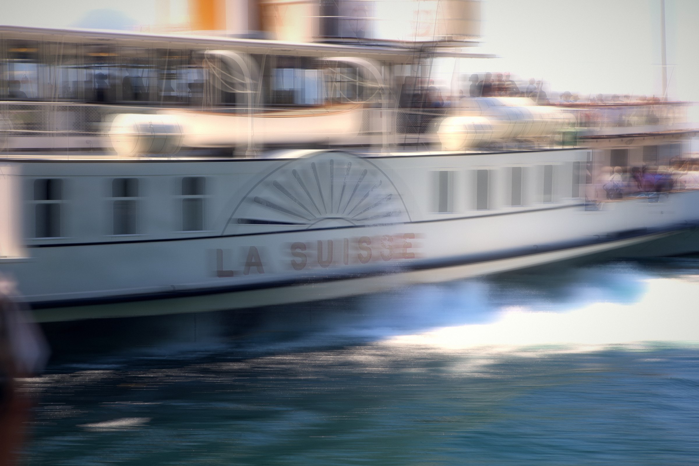 Paddle steamer La Suisse streaked sideways with motion blur.