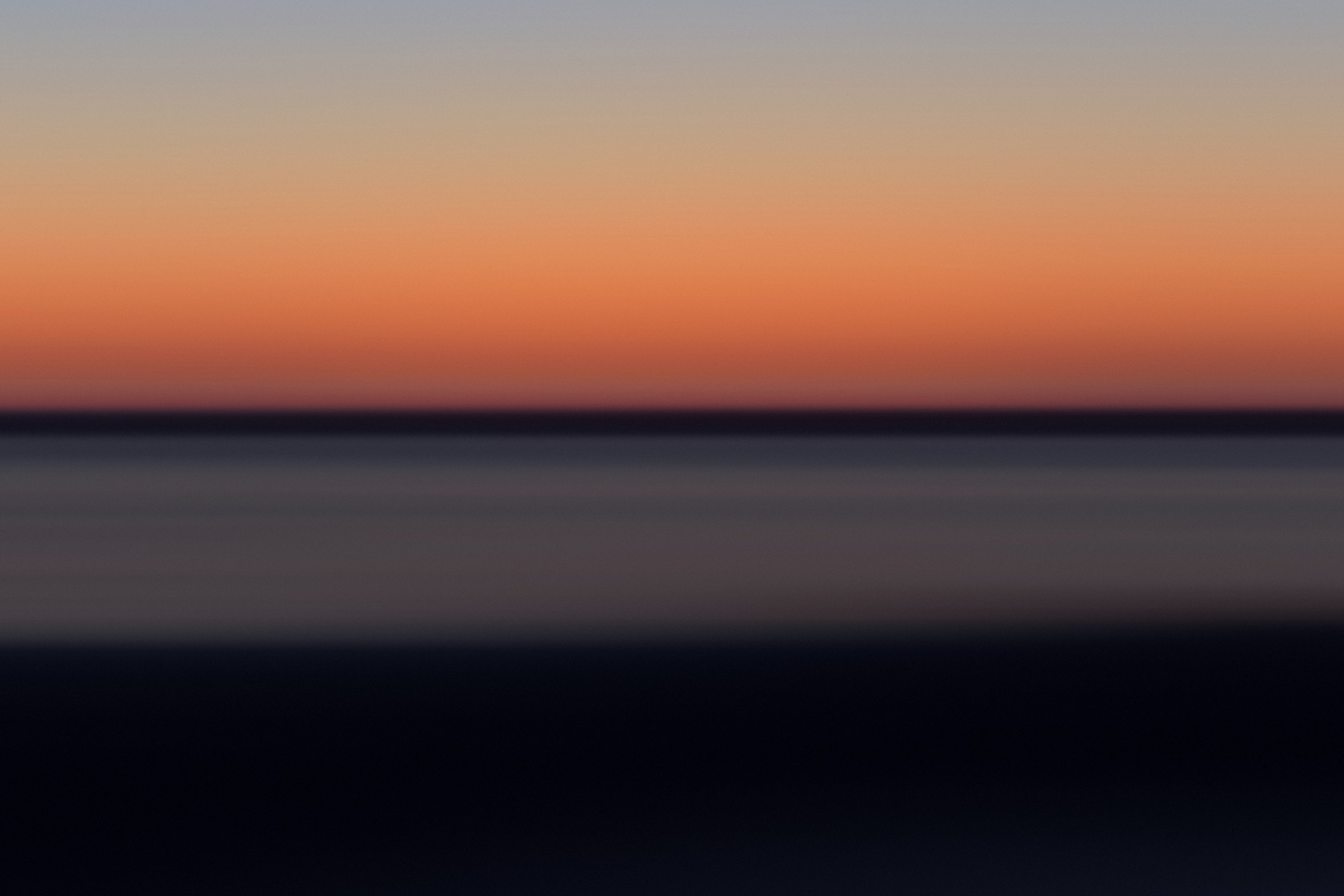 Minimal color field with a single ember-orange band between dusk blue and dark water.