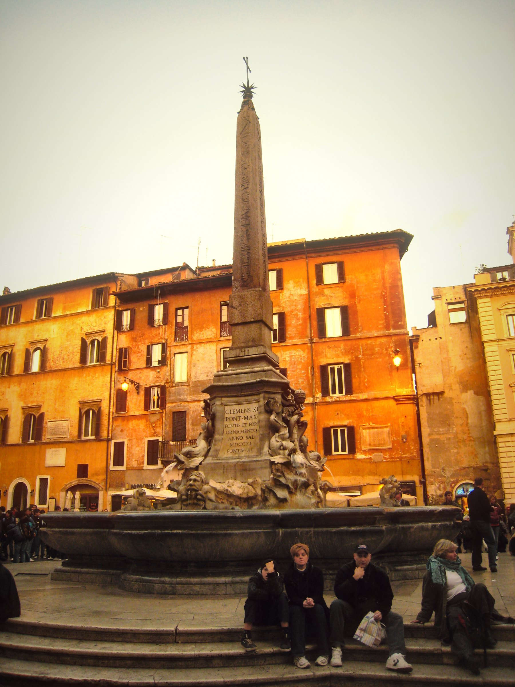 The obelisk fountain in front of the Pantheon, ochre buildings behind.