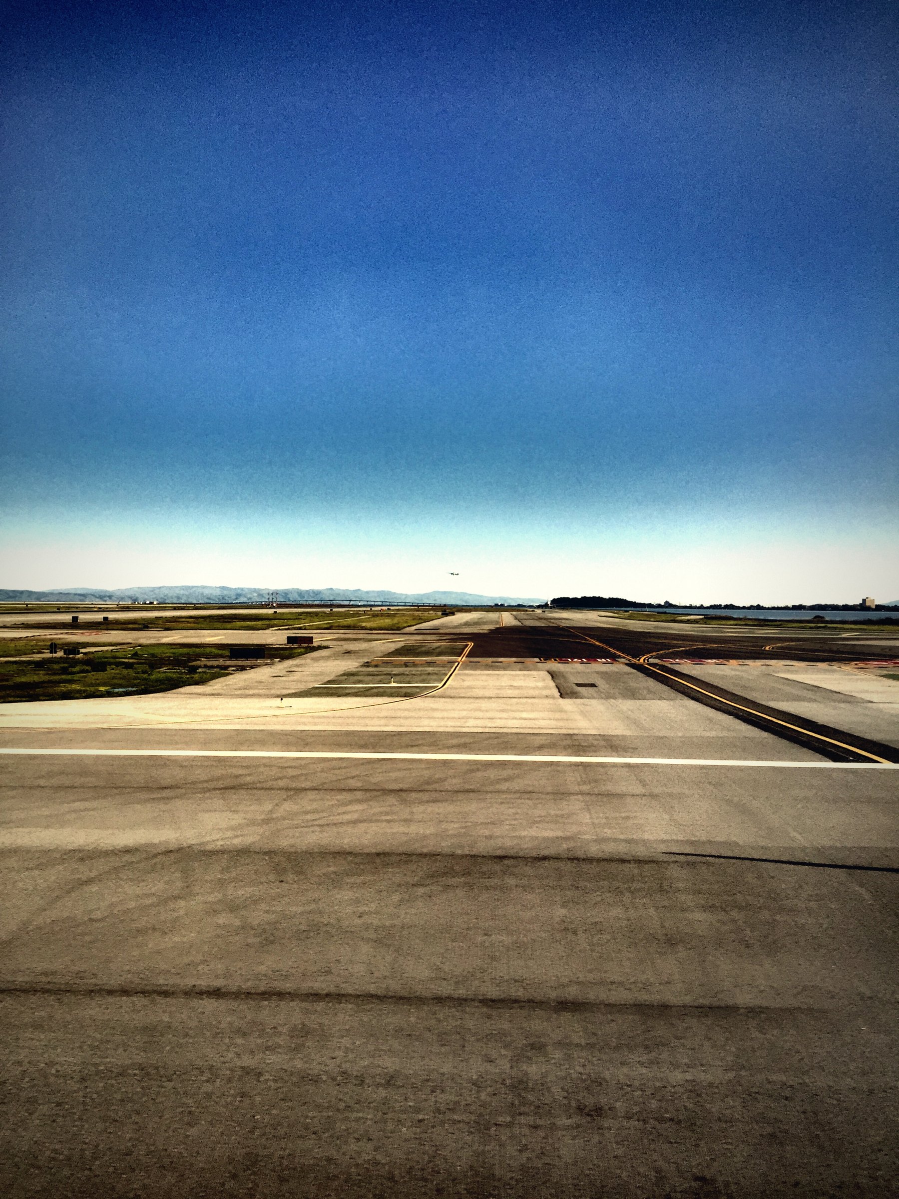 Long runway markings stretching across flat ground toward a distant horizon.