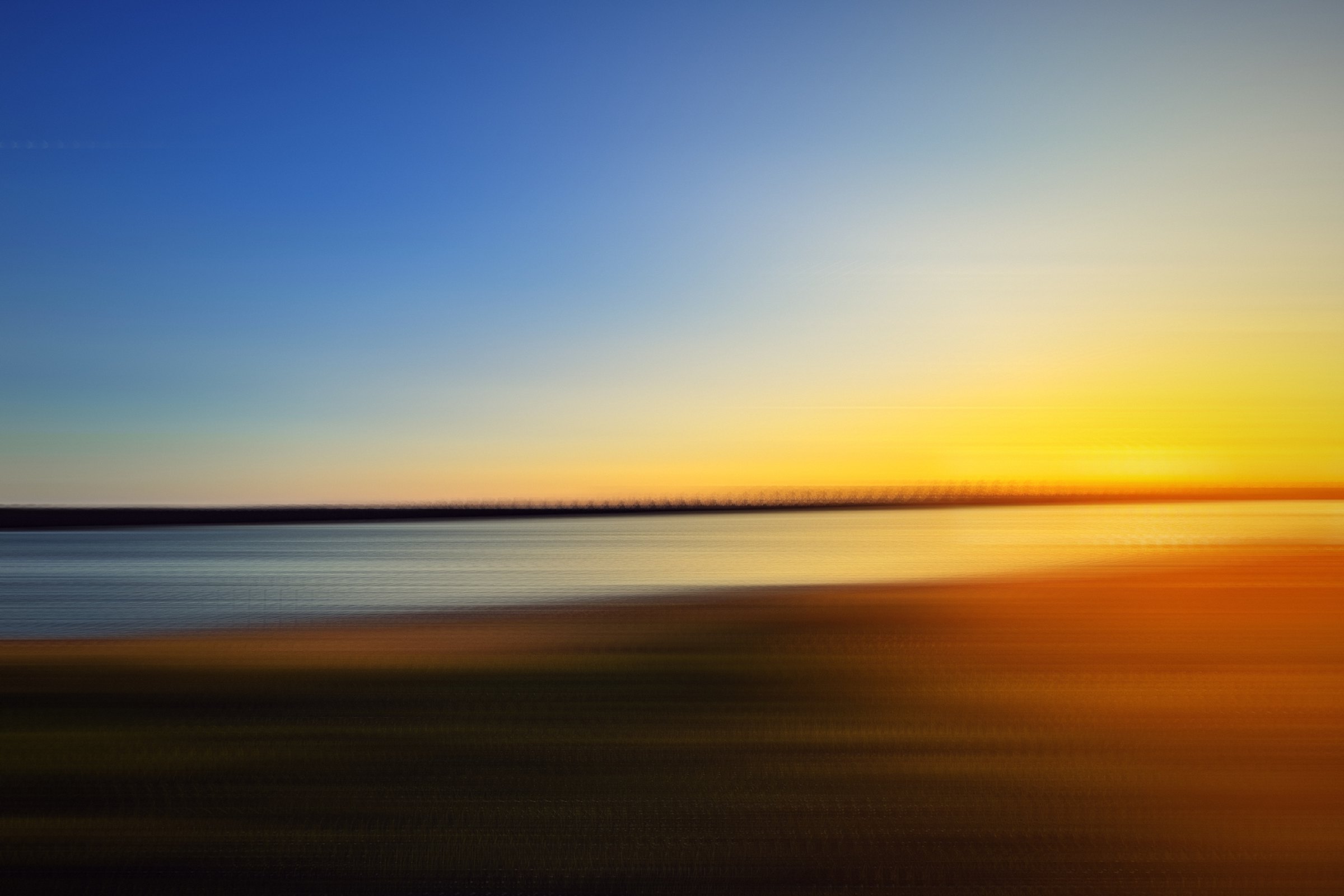 Blue and gold horizontal streaks of sky and water.