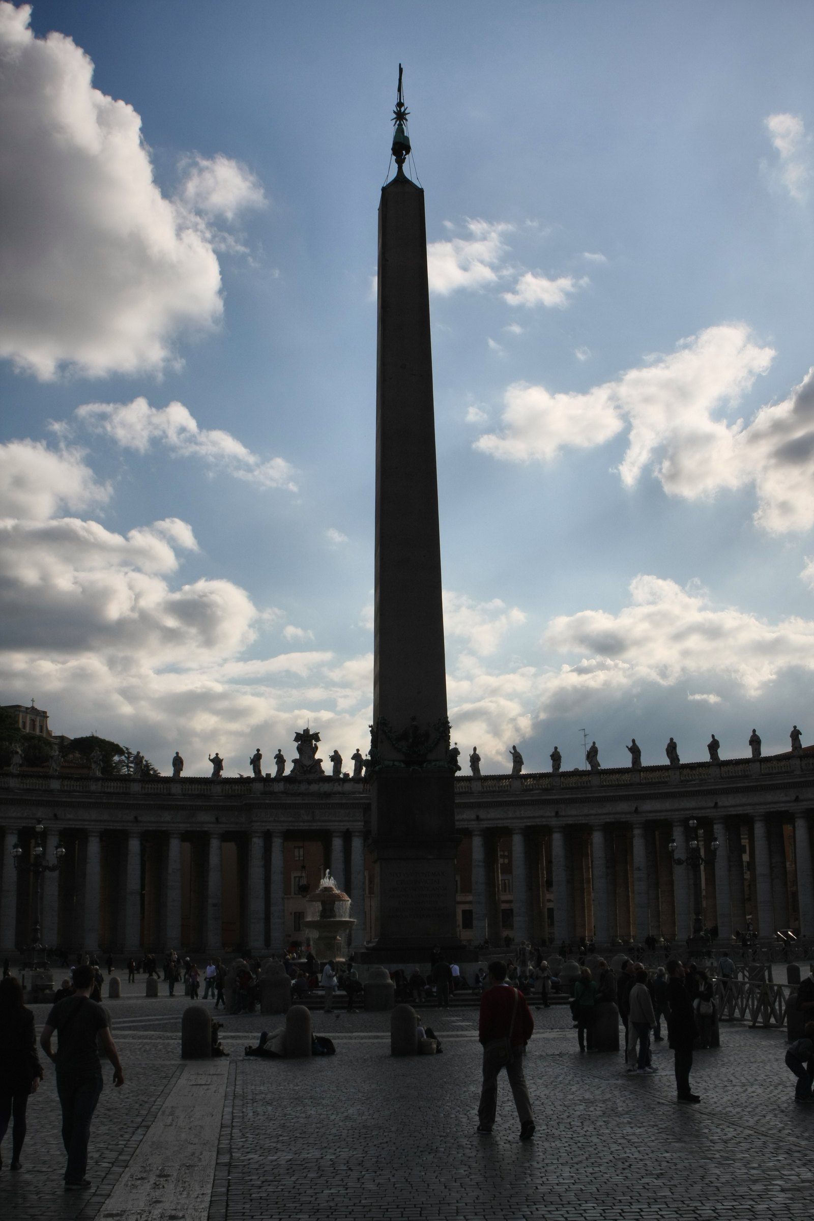 The obelisk in St Peter's Square rising against a cloudy sky.