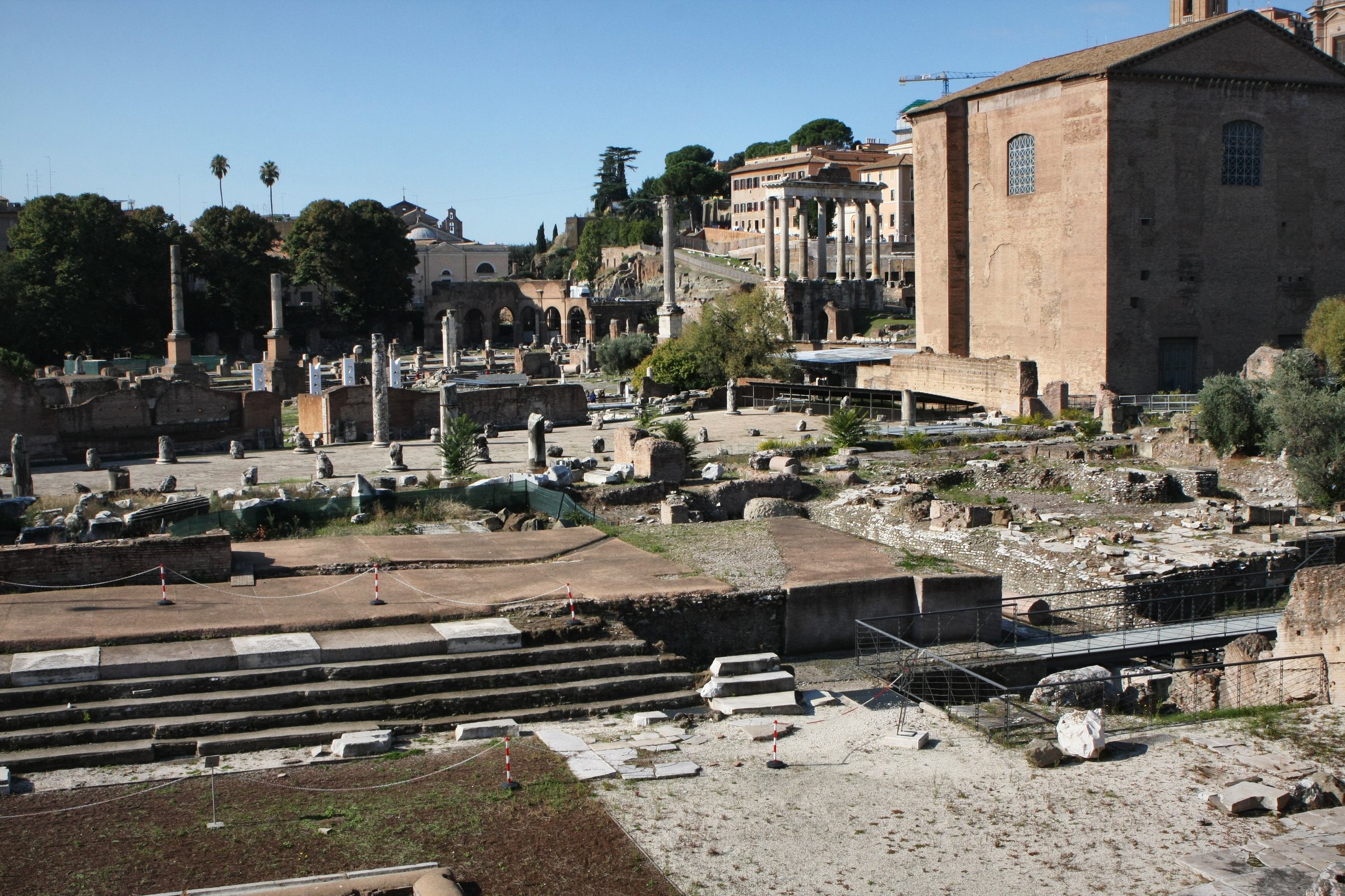 Wide view of excavated ruins in the Roman Forum.