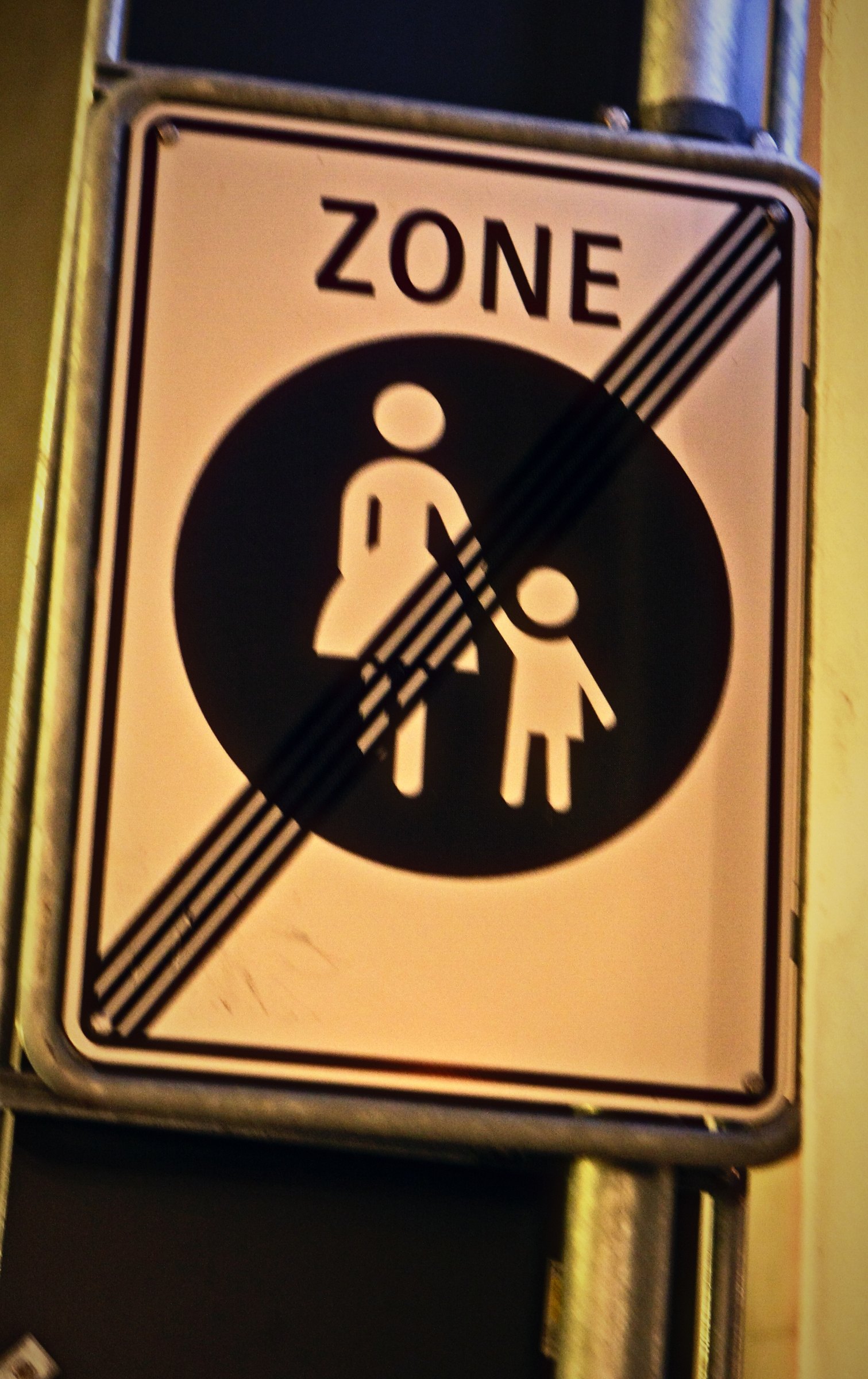 Swiss sign showing a woman and child crossed out with the word ZONE.