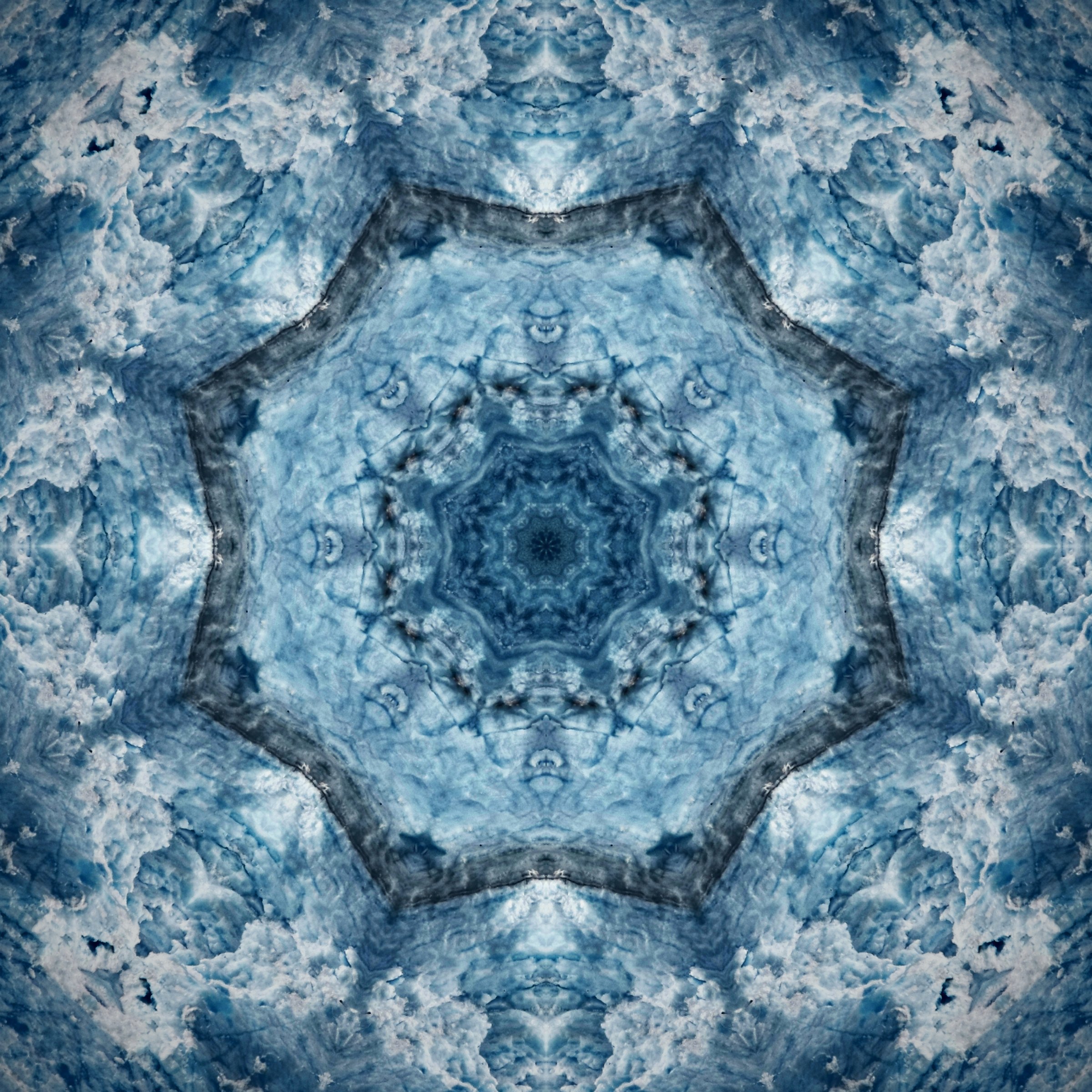Pale blue kaleidoscope of ice and snow with a lace-like pattern.