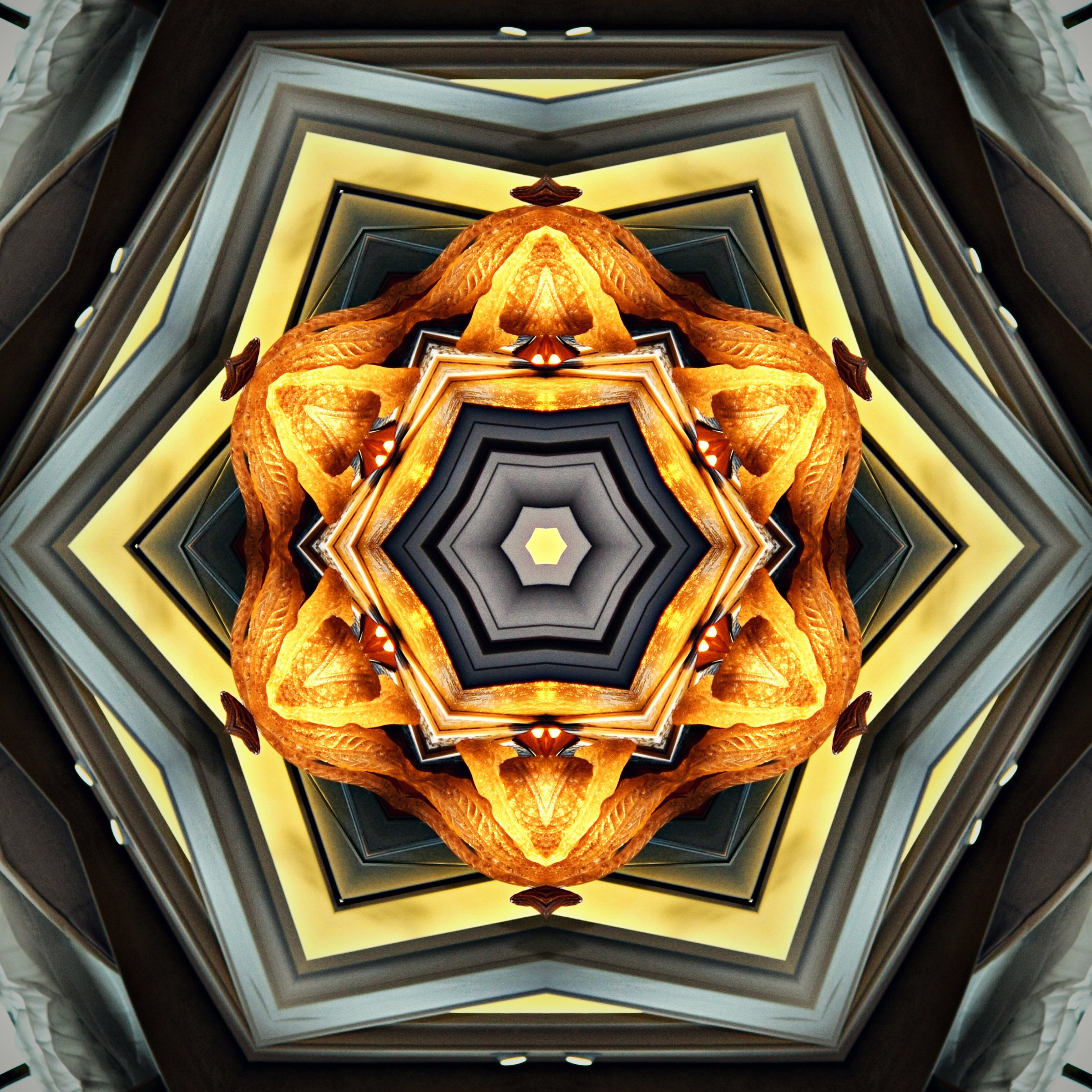 Gold and black geometric kaleidoscope like a cut gemstone.