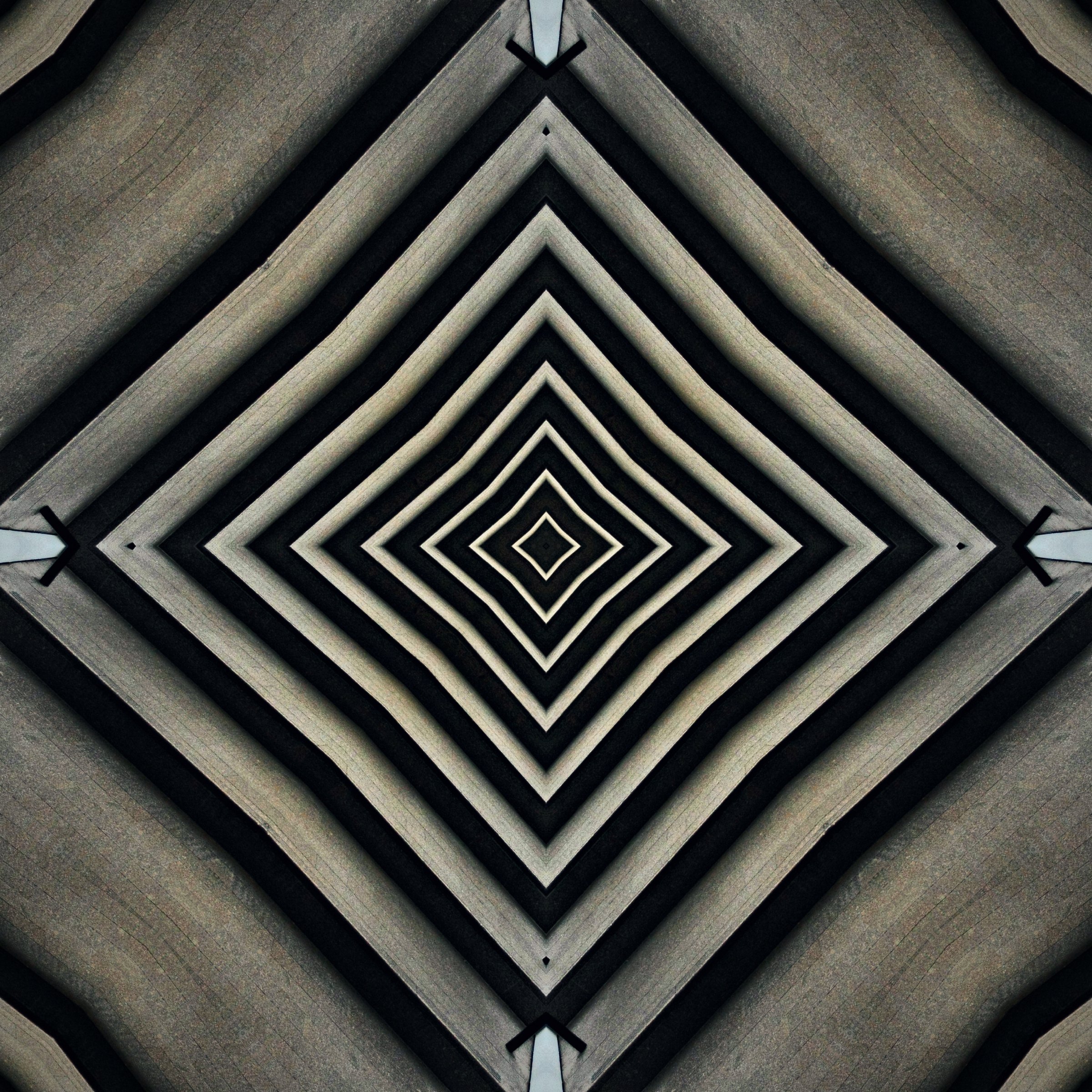 Black and white chevrons converging into a diamond tunnel.