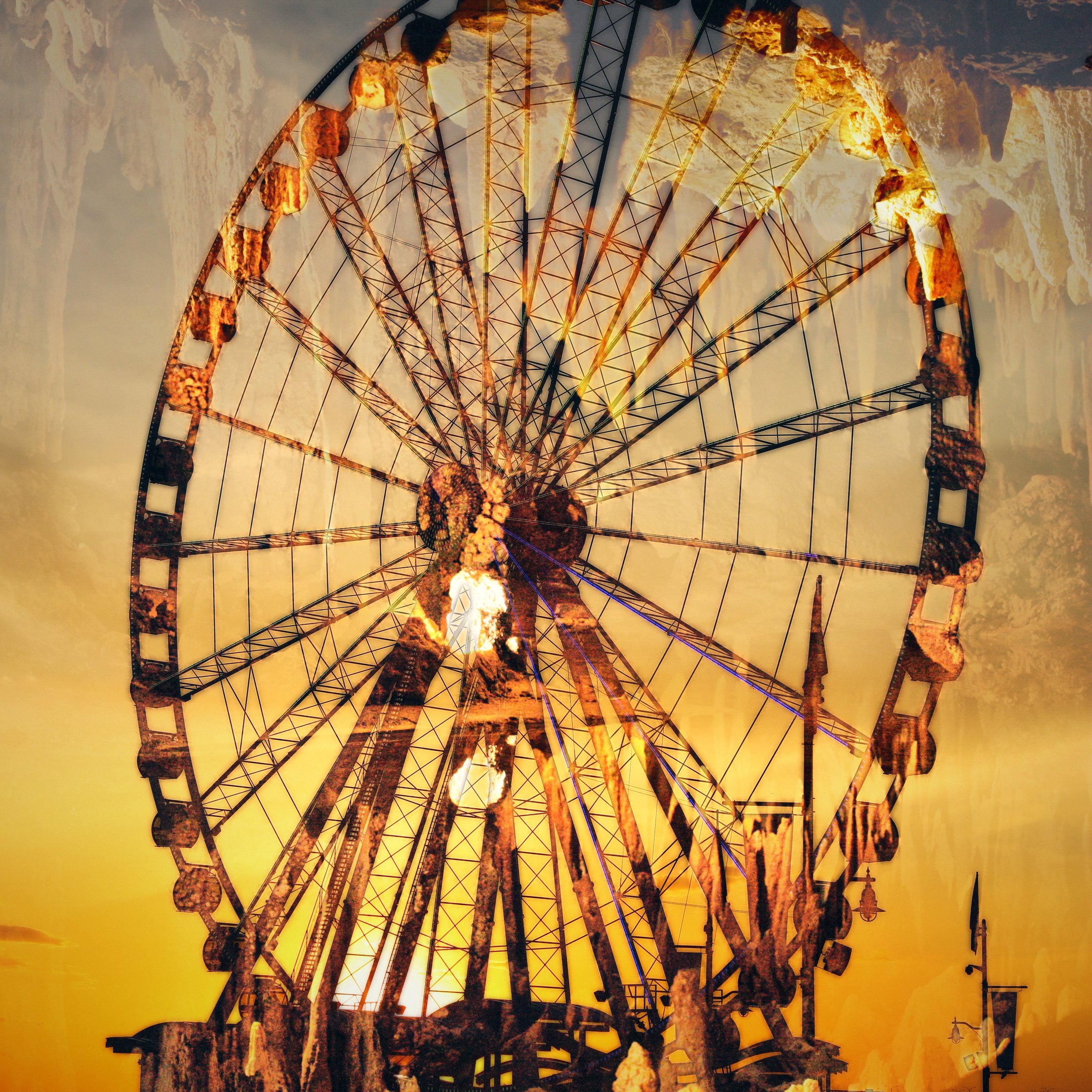 Ferris wheel silhouette filled with golden cave formations at sunset.