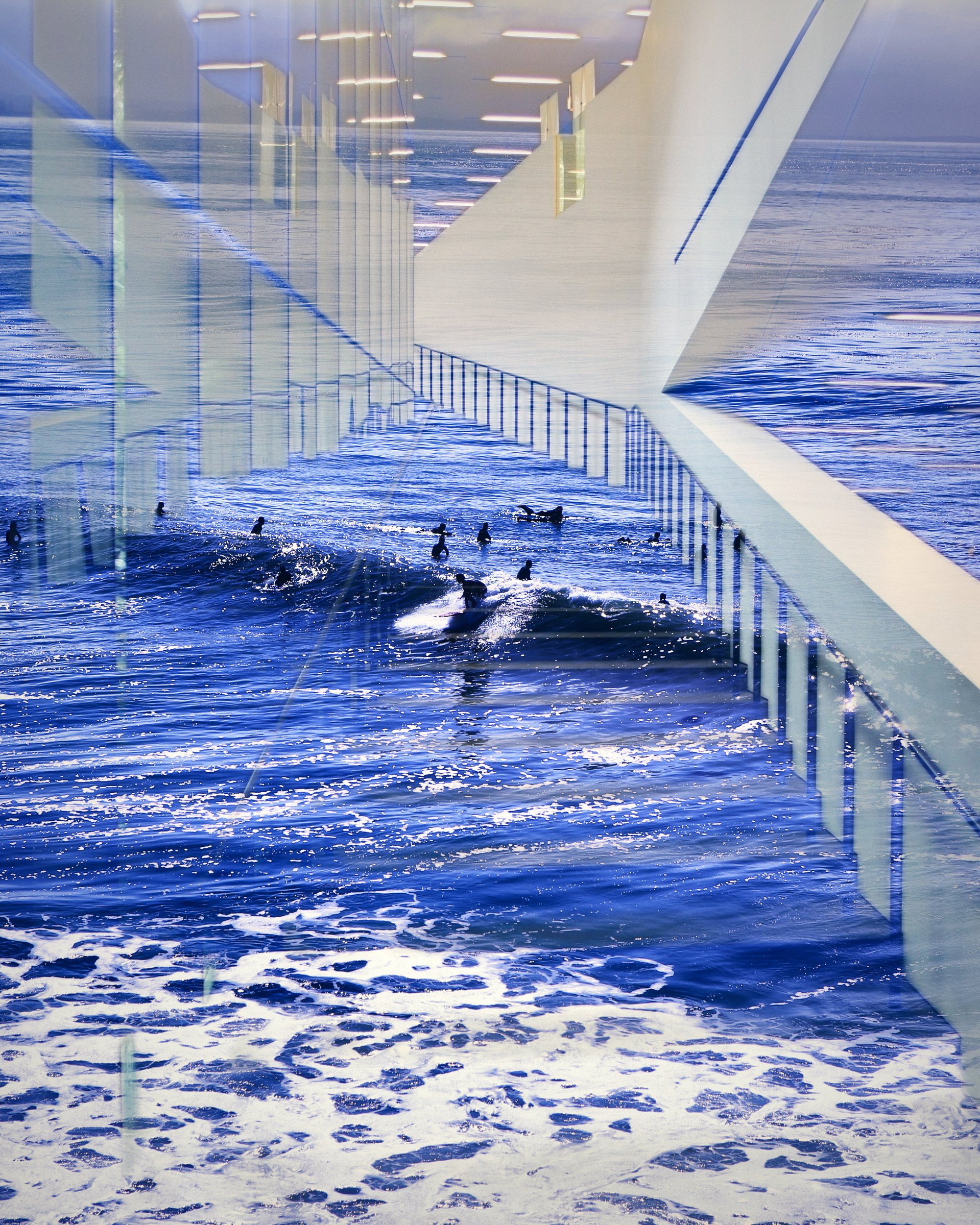 Stair railings and a walkway layered over deep blue surf.