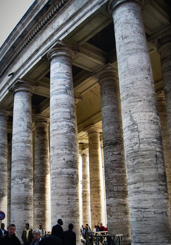 Massive columns of Bernini's colonnade at St Peter's Square marching into the distance.