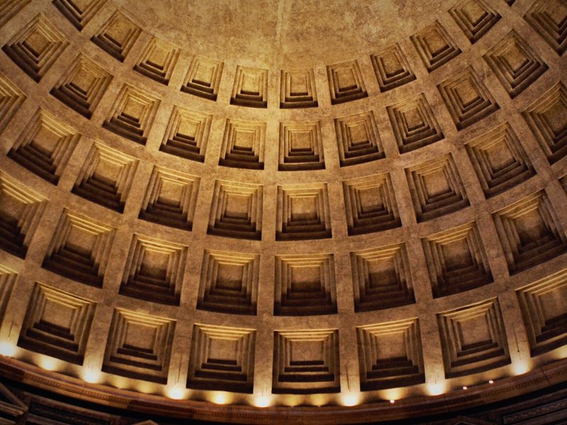 The lit coffered ceiling of the Pantheon's dome, ring after ring.