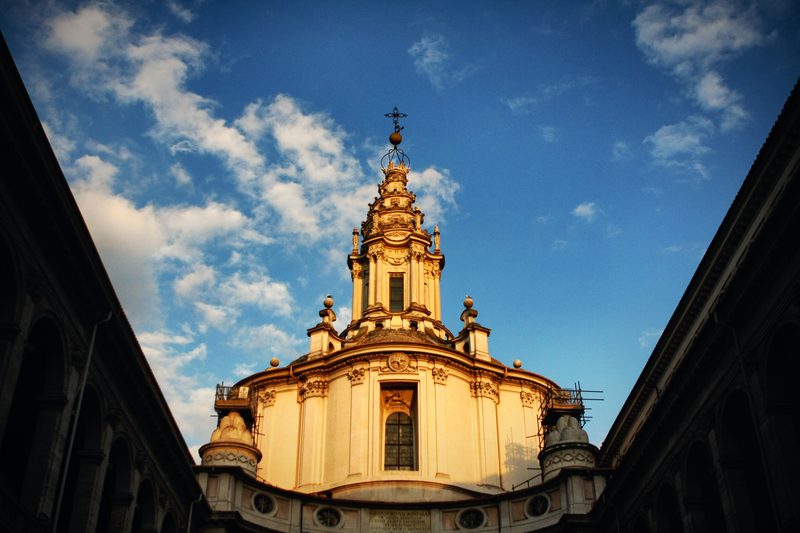 The spiralling lantern of Sant'Ivo alla Sapienza rising between two courtyard walls.