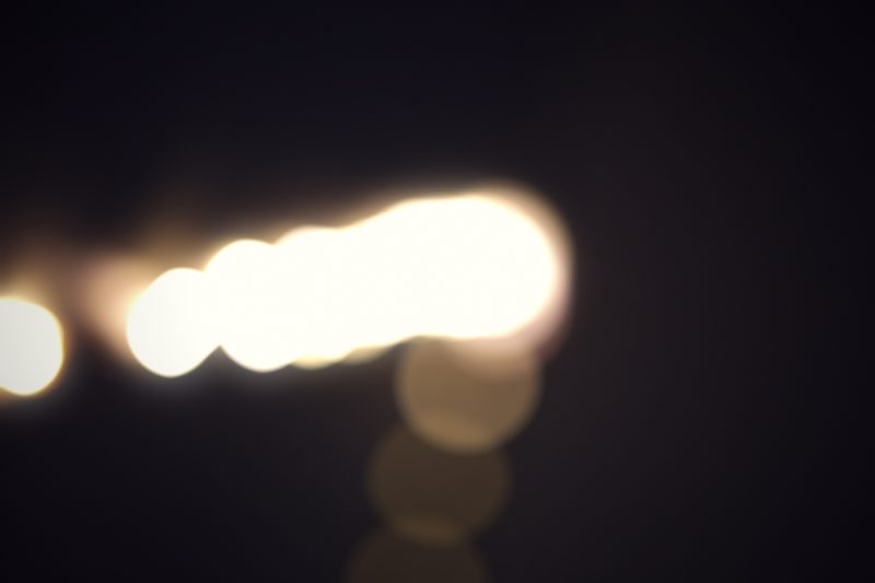 Soft white and gold orbs drifting through the dark.