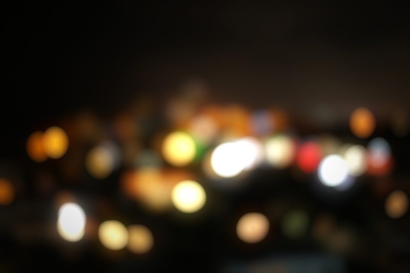 Multicolored city lights blurred into soft round bokeh.