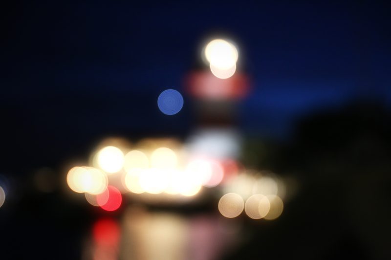 Boat and harbor lights dissolved into red, white and blue orbs.