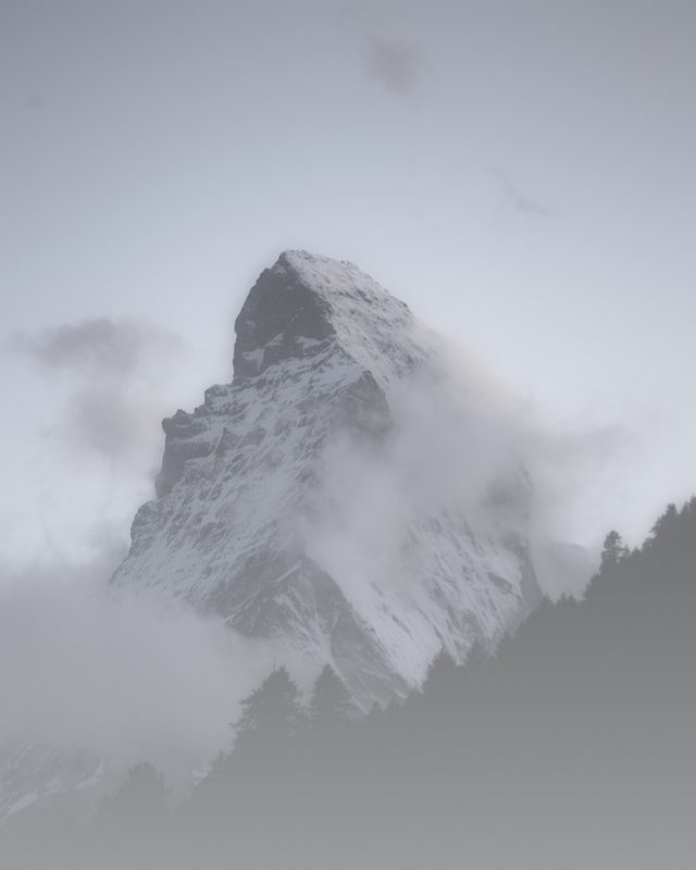 High-key misty image of the Matterhorn fading into pale cloud.