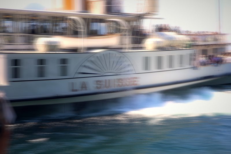 Paddle steamer La Suisse streaked sideways with motion blur.