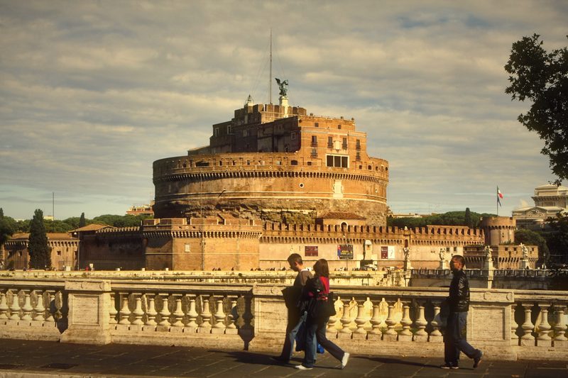 Castel Sant'Angelo glowing warm beside the riverside balustrade.