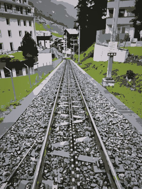 Posterized rack railway track running straight up between green meadows and chalets.