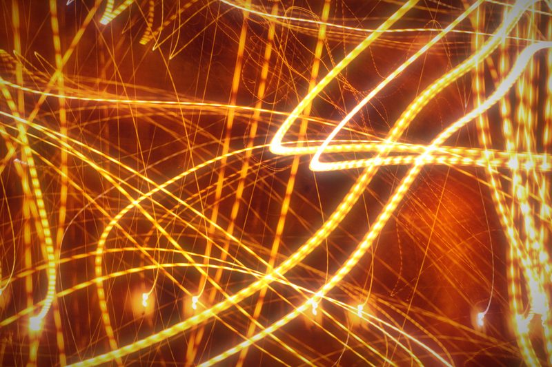 Streaks of gold street light looping and crossing across the frame.