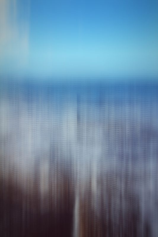 Vertical streaks of pale blue and white over dark ground.