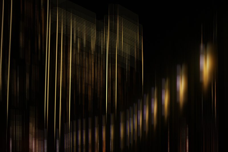 Thin vertical lines of gold light on black.