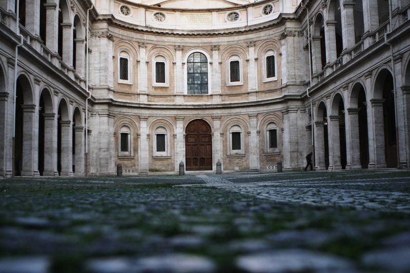The cobbled courtyard of Sant'Ivo alla Sapienza leading to the church front.