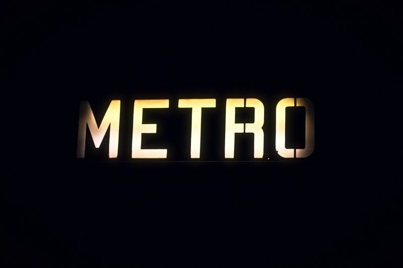 Backlit METRO letters glowing on black.