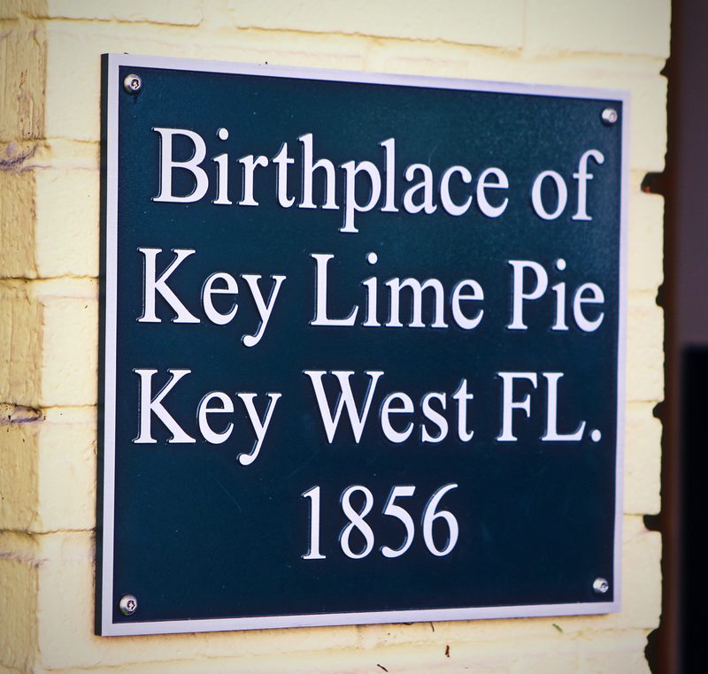 Dark green plaque reading Birthplace of Key Lime Pie, Key West FL. 1856.