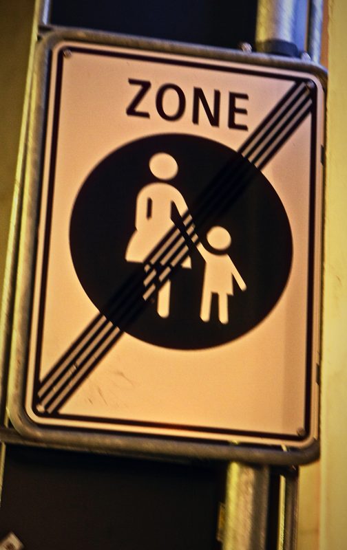 Swiss sign showing a woman and child crossed out with the word ZONE.