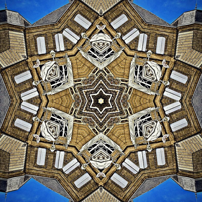 Gold and cream kaleidoscope of stonework and windows with a star at its center.