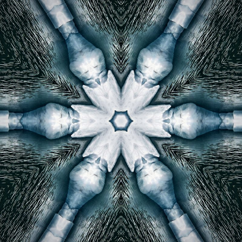 Kaleidoscope of blue-gray ice with a white six-pointed star in the middle.
