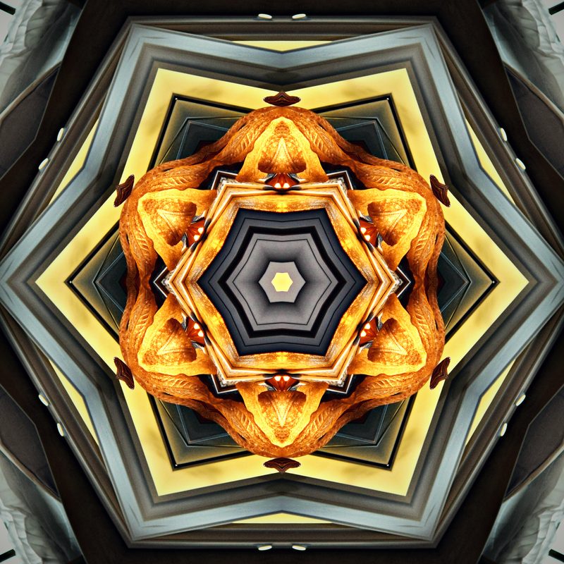 Gold and black geometric kaleidoscope like a cut gemstone.