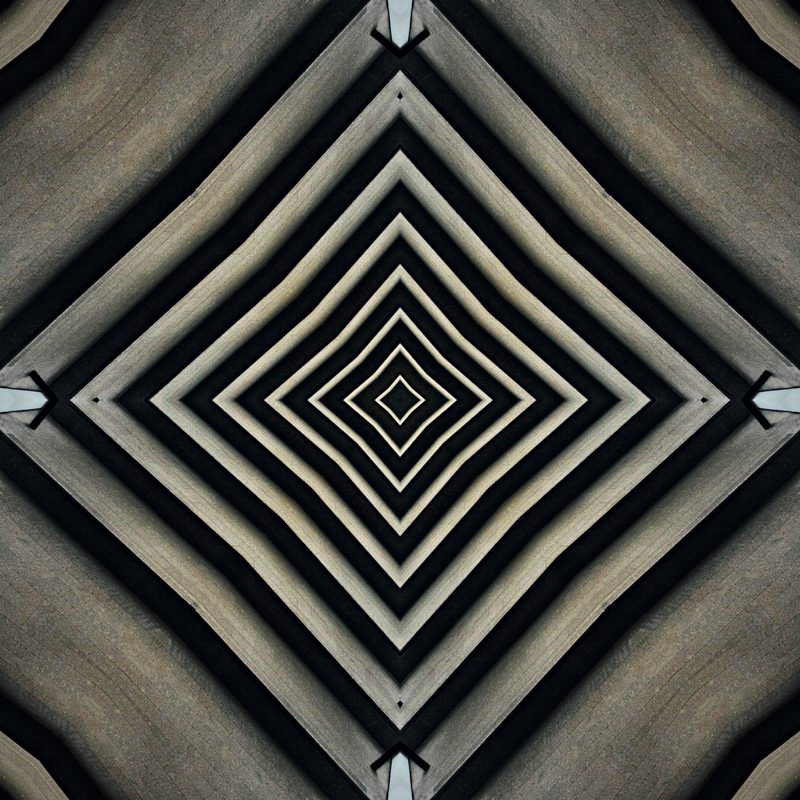 Black and white chevrons converging into a diamond tunnel.