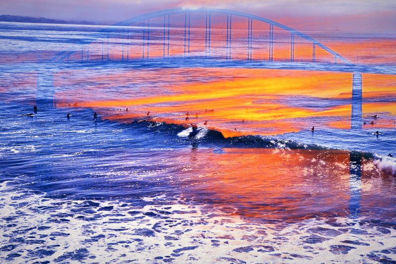 Bridge at sunset layered with blue surf in orange and violet.