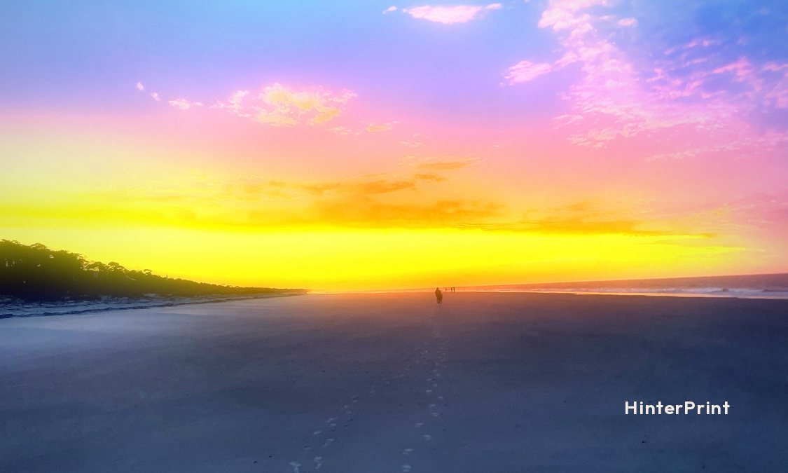 Front of the tag: a pink and violet sky over a bright yellow sunset on a beach, with a small HinterPrint mark.